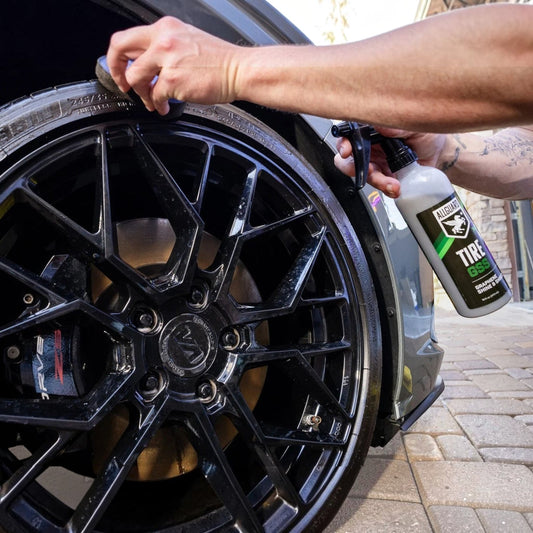 T-Top Vibes AllGuard Tire GSS graphene tire dressing being applied to a black car tire with an applicator pad