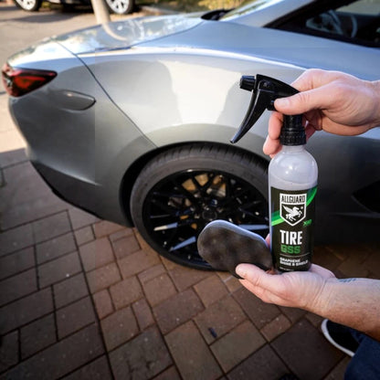 T-Top Vibes AllGuard Tire GSS graphene tire dressing bottle and applicator pad held in front of a car tire