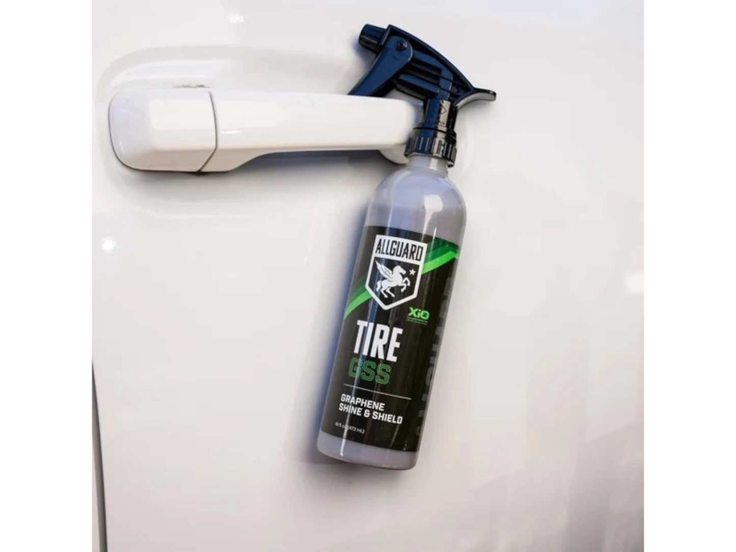 T-Top Vibes AllGuard Tire GSS graphene tire dressing spray bottle with a black trigger sprayer on a white car door
