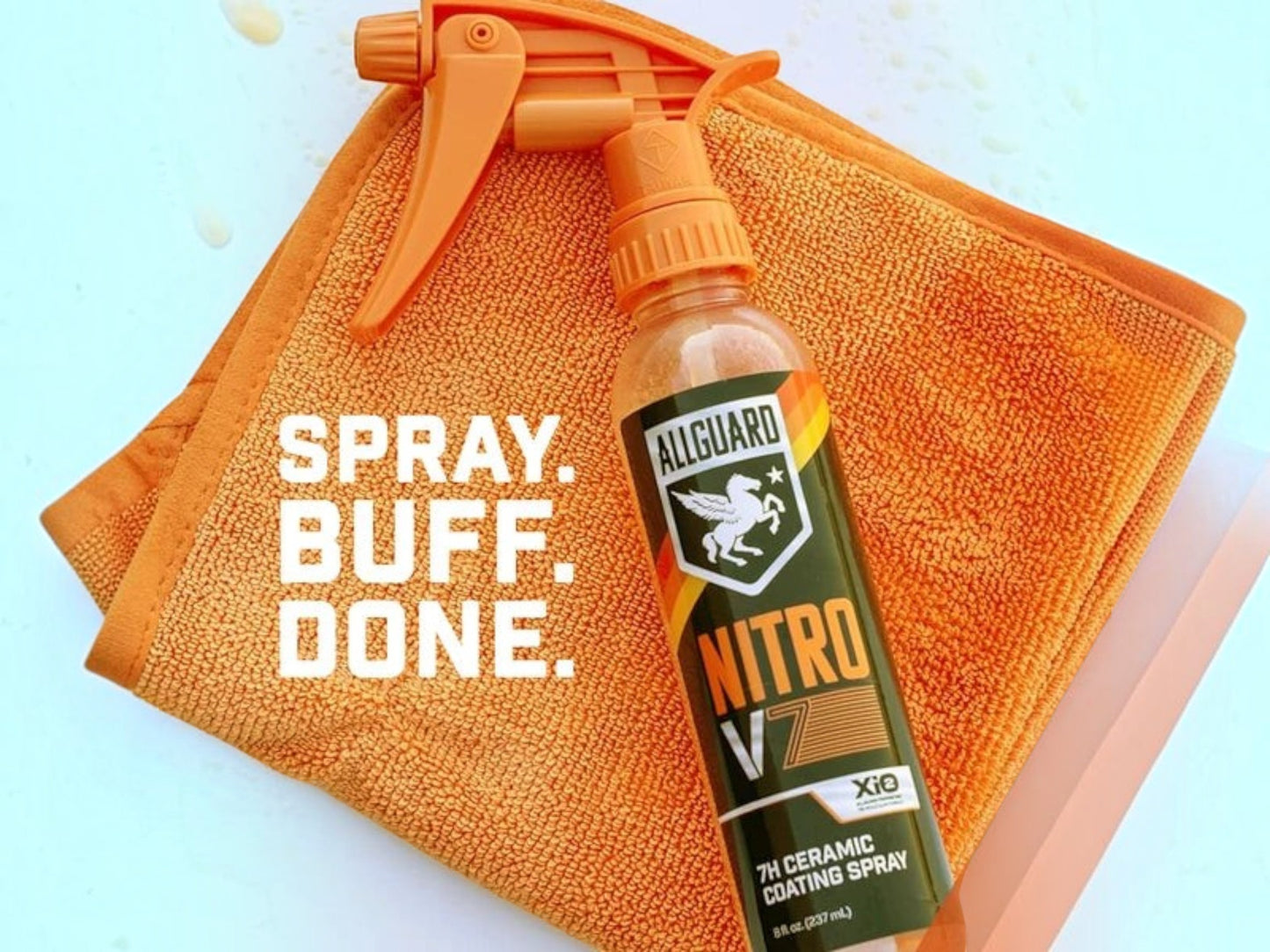 T-Top Vibes AllGuard NITRO V7 7H ceramic spray coating bottle with an orange microfiber towel on a white surface.