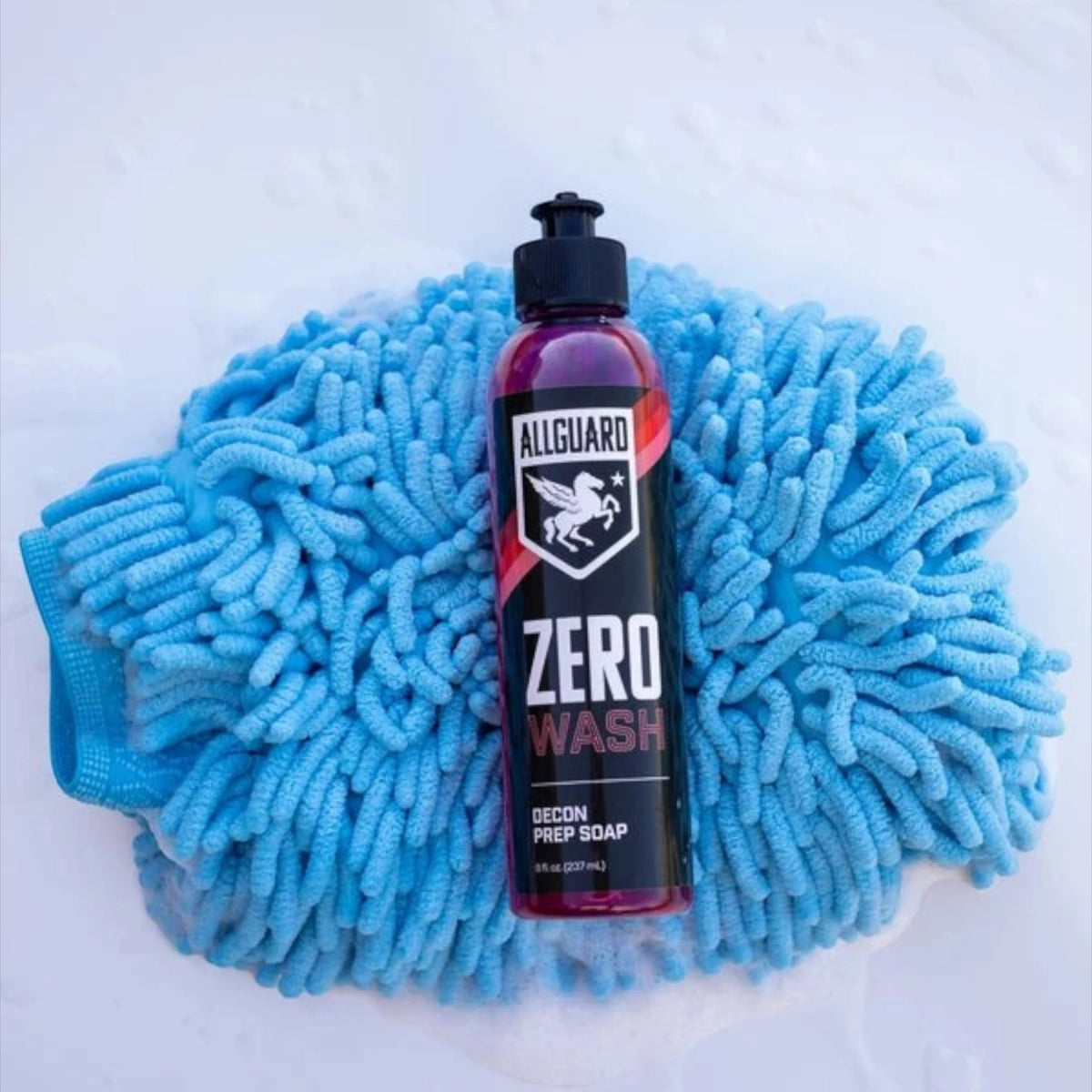 T-Top Vibes AllGuard ZERO decontamination wash soap bottle resting on a blue microfiber car wash mitt