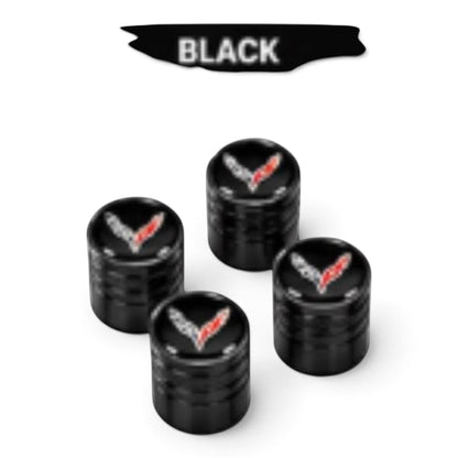 T-Top Vibes black anodized billet aluminum Corvette C8 valve stem caps with crossed-flags emblem and diamond-cut grip.