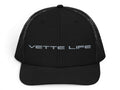T-Top Vibes black trucker hat with Vette Life embroidered on the front, featuring a structured fit and mesh back.