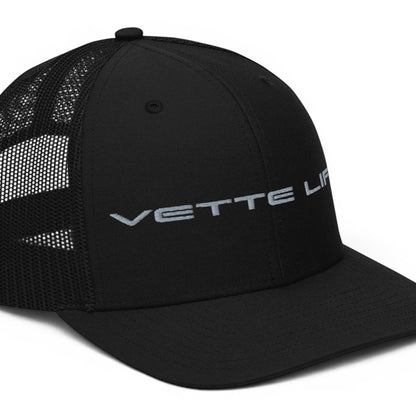 T-Top Vibes black trucker hat with Vette Life embroidery, structured front panels, and breathable mesh back.