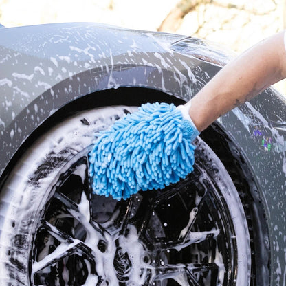 T-Top Vibes blue chenille microfiber car wash mitt cleaning a soapy vehicle wheel with an elastic wrist cuff