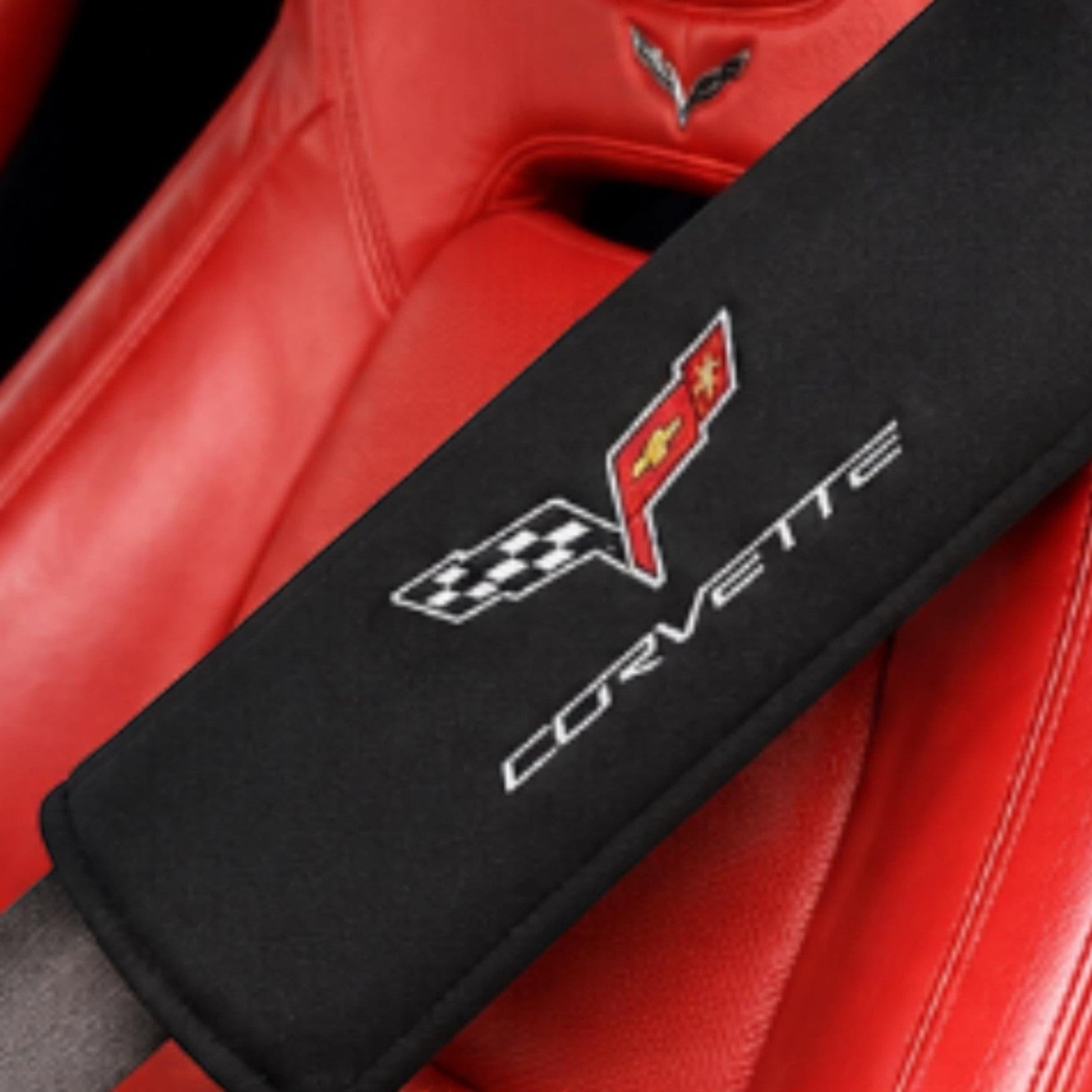 T-Top Vibes black C6 Corvette seat belt cover with embroidered crossed flags logo