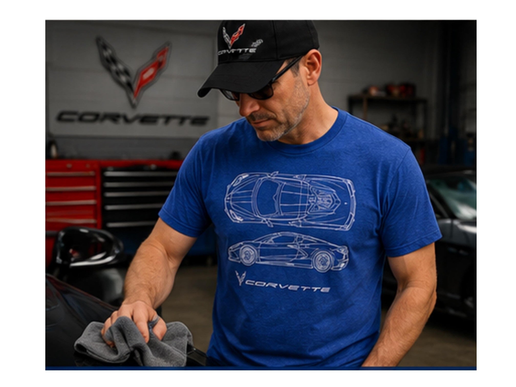 T-Top Vibes heather royal blue C8 Corvette blueprint graphic t-shirt worn by a man in a garage setting.