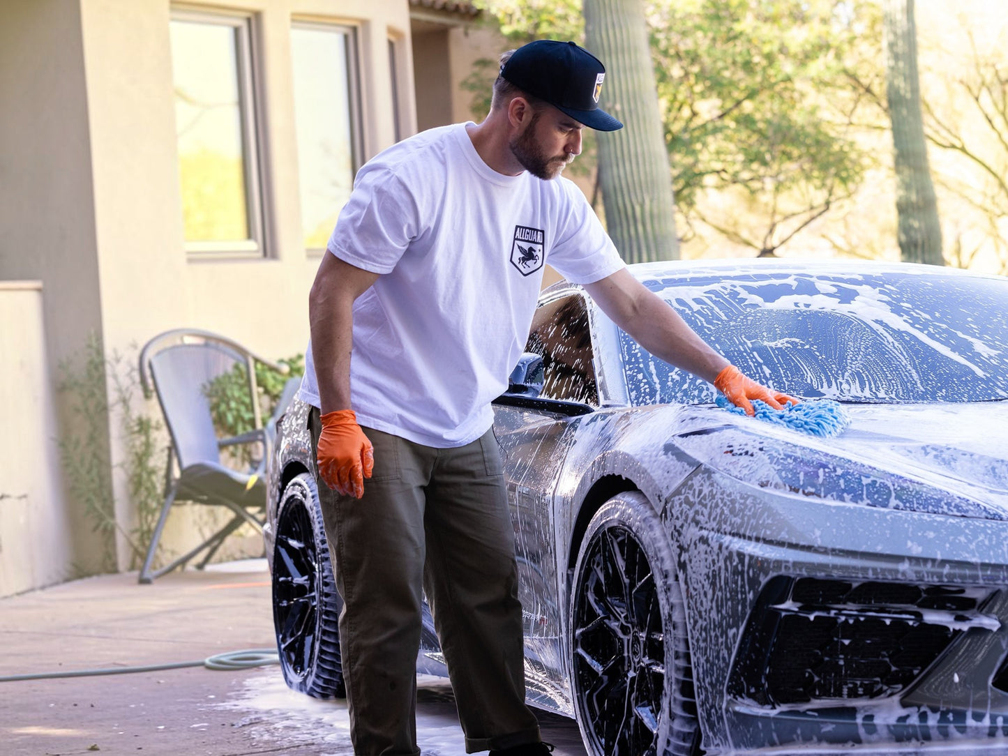 T-Top Vibes man washing a grey sports car with AllGuard VLUX ceramic soap and a blue microfiber mitt