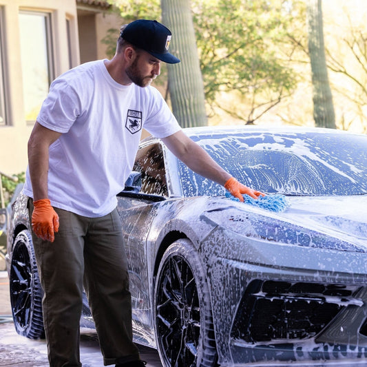 T-Top Vibes man washing a grey sports car with AllGuard VLUX ceramic soap and a blue microfiber mitt