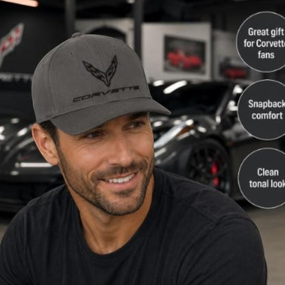 T-Top Vibes charcoal C8 Corvette baseball cap with tonal flag logo on a man in a garage setting