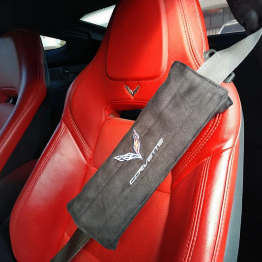 T-Top Vibes black suede C7 Corvette seat belt cushion installed on a red leather car seat