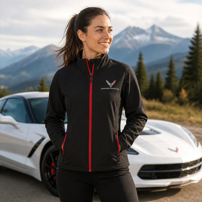 T-Top Vibes Corvette C8 ladies black soft shell jacket with red zipper details and embroidered emblem, worn outdoors.