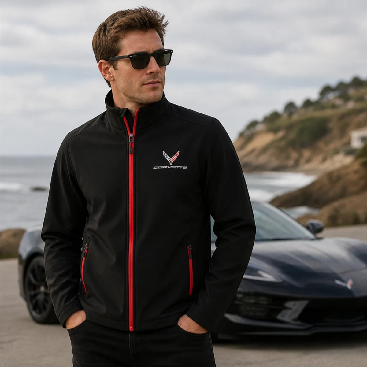 T-Top Vibes Corvette C8 black soft shell jacket with red zipper details and embroidered emblem worn by a man outdoors