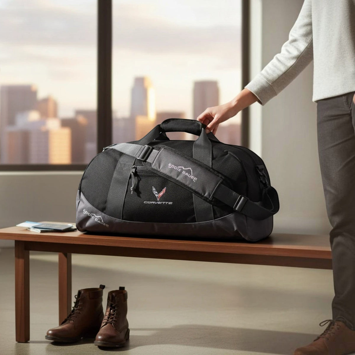 T-Top Vibes black Eddie Bauer medium duffel bag with embroidered Corvette emblem sitting on a wooden bench