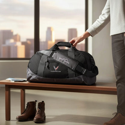 T-Top Vibes black Eddie Bauer medium duffel bag with embroidered Corvette emblem sitting on a wooden bench