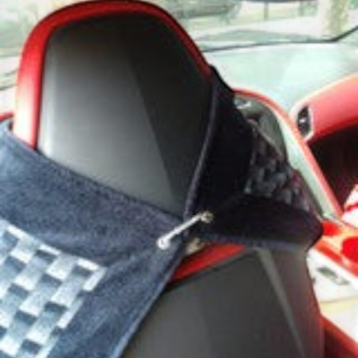 T-Top Vibes Corvette Generations seat cover towel attached to a car headrest with a carbon fiber pattern