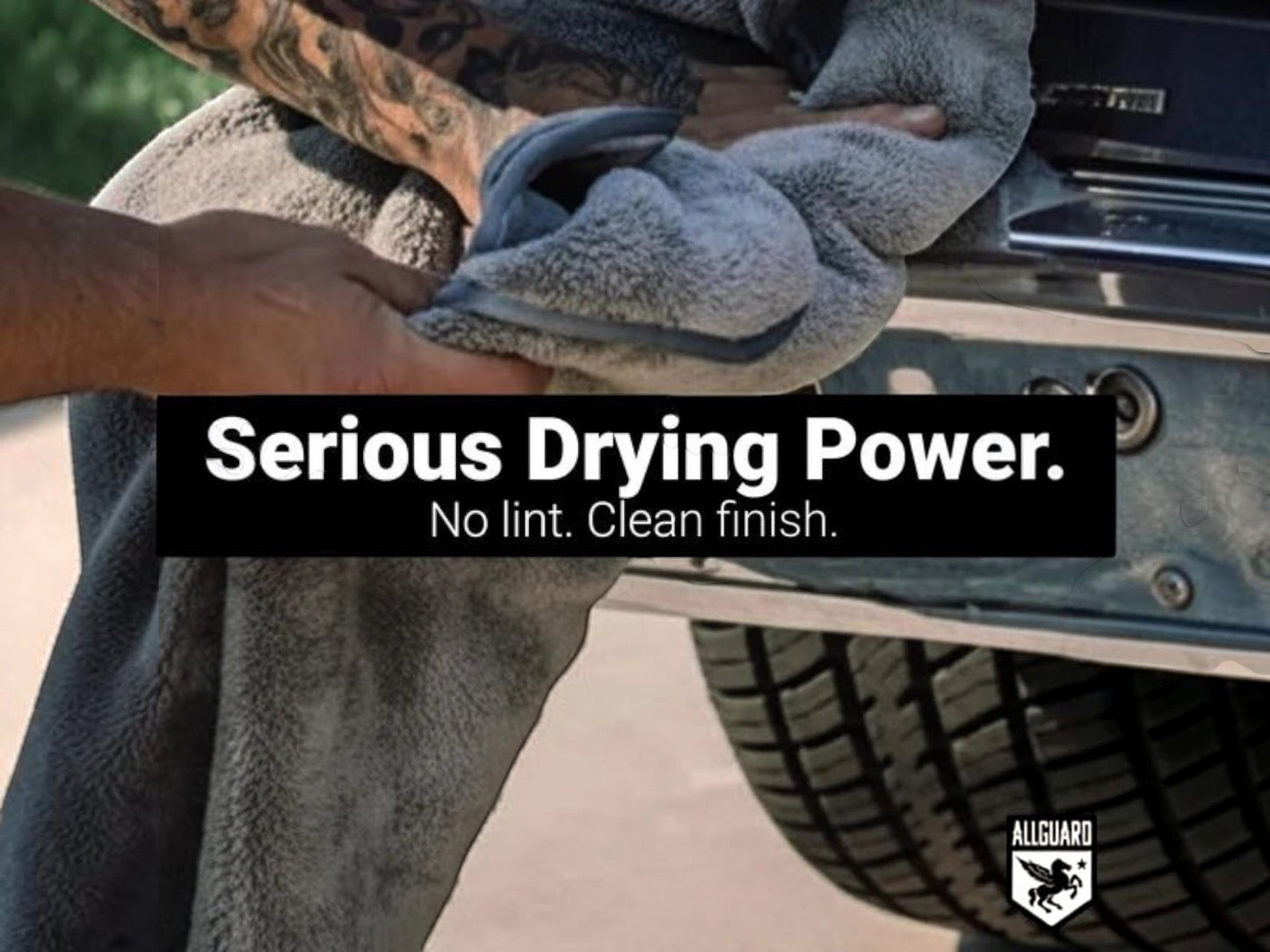 T-Top Vibes gray plush microfiber car drying towel being used to dry a vehicle bumper for a streak-free finish