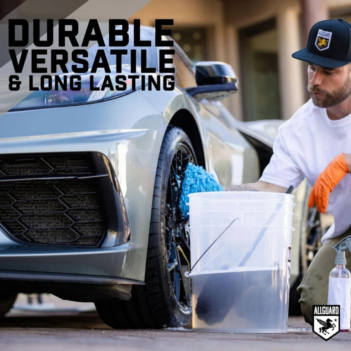 T-Top Vibes man using a blue AllGuard VLUX microfiber wash mitt to clean a car wheel with a bucket of soapy water