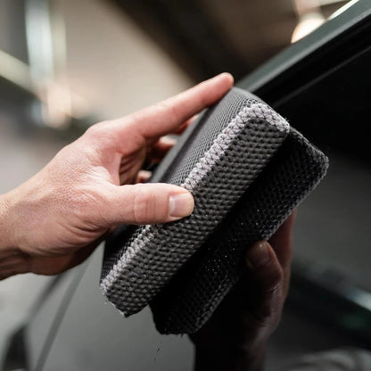 T-Top Vibes reusable clay scrubber for car detailing being held by a hand to demonstrate its textured surface