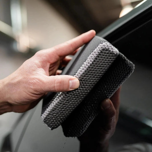 T-Top Vibes reusable clay scrubber for car detailing being held by a hand to demonstrate its textured surface