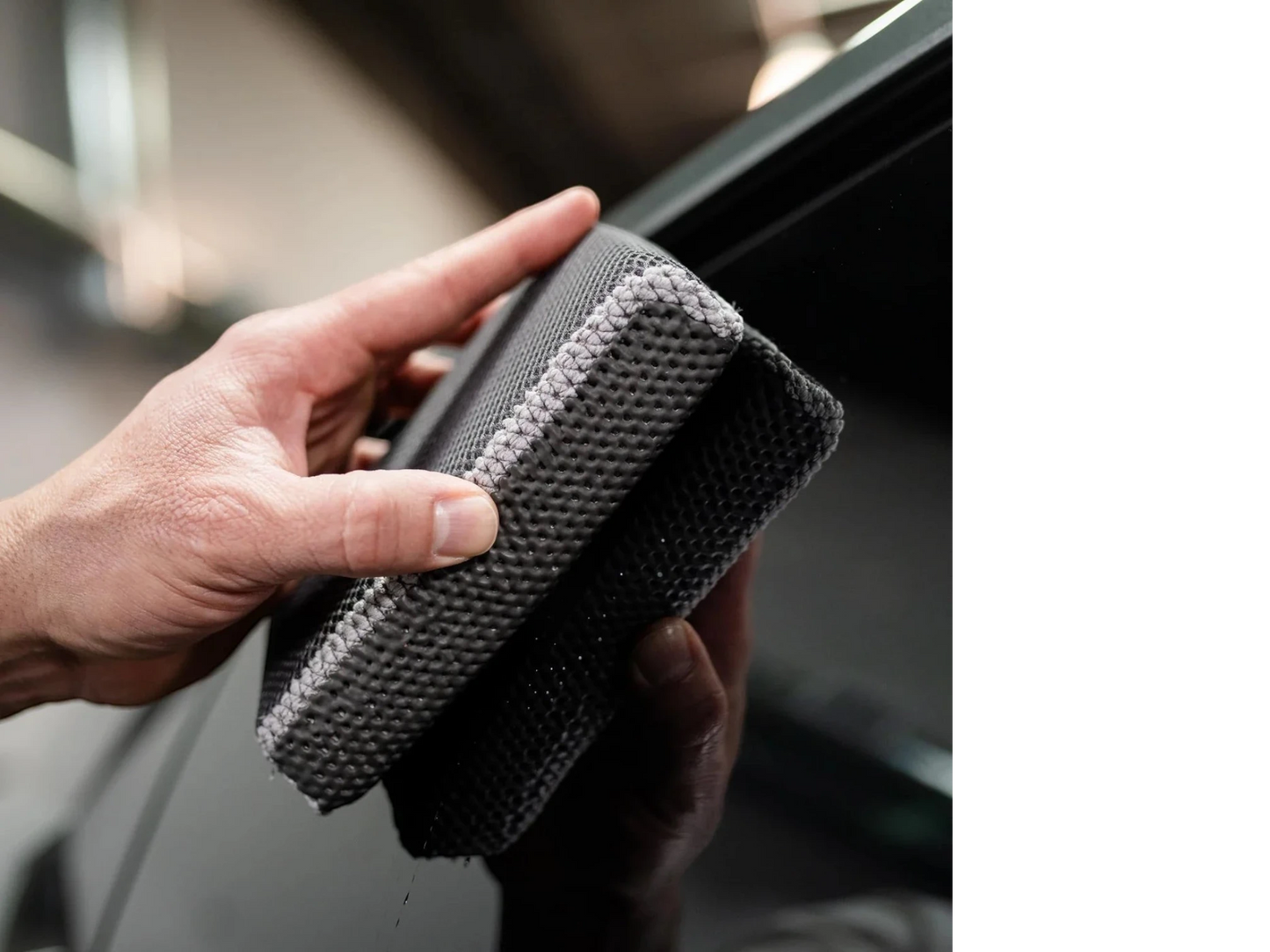 T-Top Vibes reusable clay scrubber for car detailing being held by a hand to demonstrate its textured surface