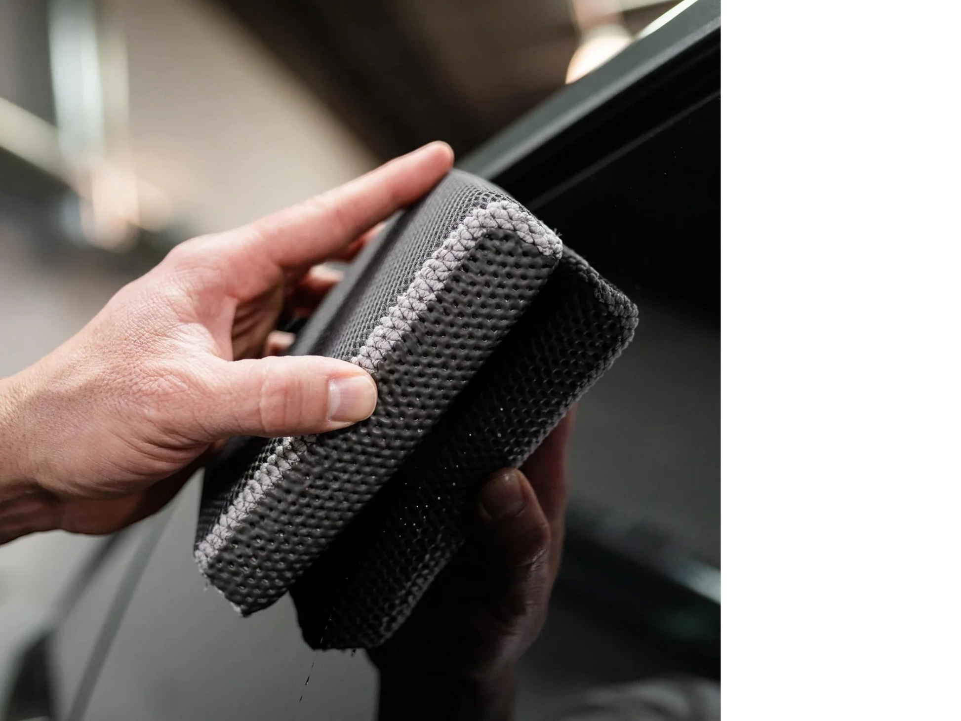 T-Top Vibes reusable clay scrubber for car detailing being held by a hand to demonstrate its textured surface